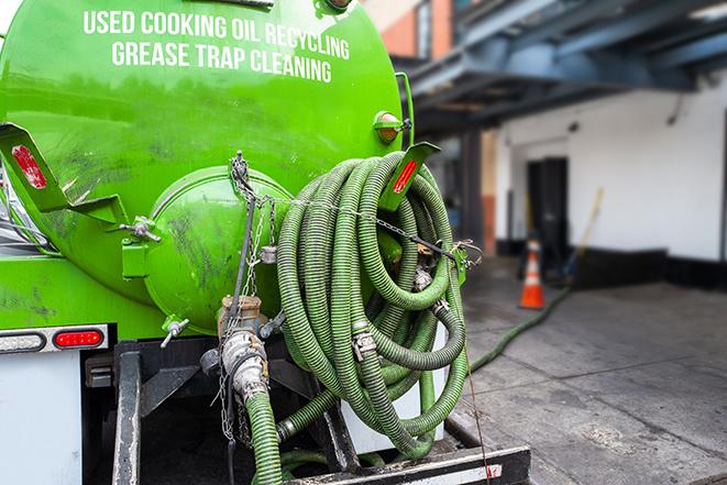 grease trap pumping truck servicing a restaurant in Bay Pines